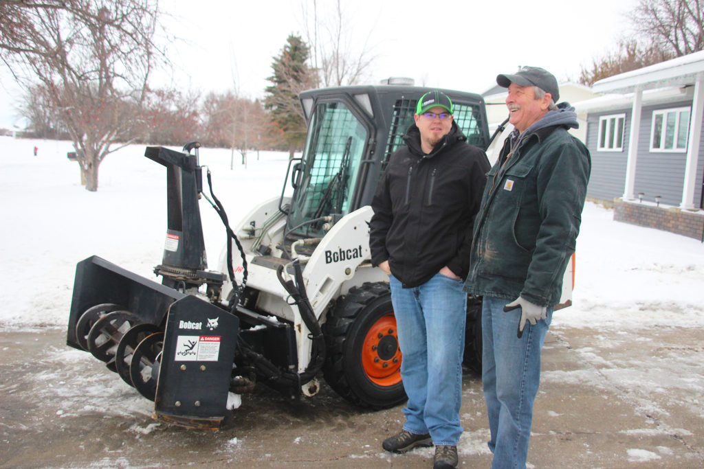 Jasper Jacobson and Bill Howden share a conversation. Jacobson recently purchased a snow removal and irrigation business from Howden. 